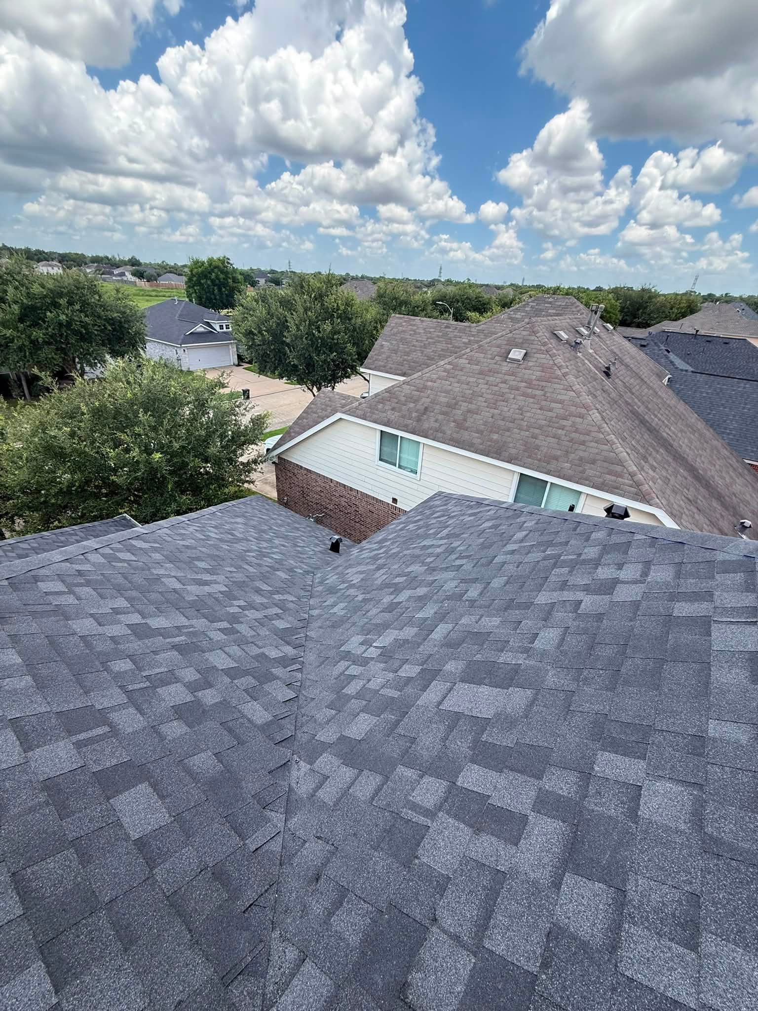 Newly installed hip roof with clean ridge lines on a Houston home