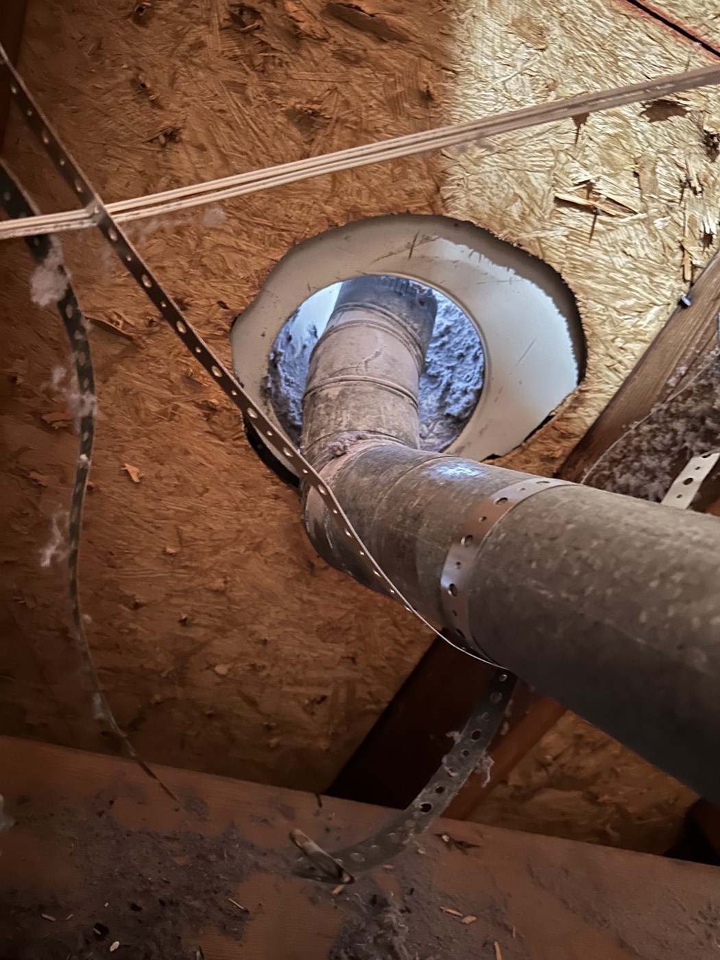 Attic inspection identifying a roof penetration and ventilation