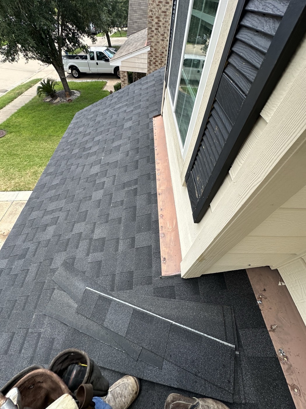 New shingles and flashing being installed on a Houston home